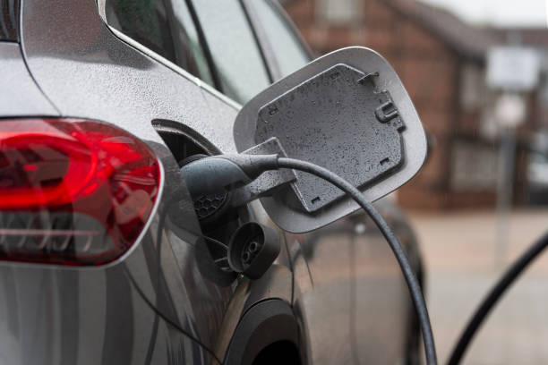 istock Electric car is connected to the charging station - it is raining 1767195274