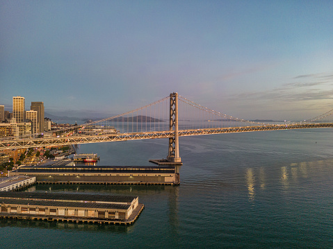 Aerial view of the Bay Bridge at sunrise on a calm morning.