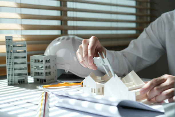 istock Architectural engineer man, contractors, designers, sketches, blueprints and construction work for architectural buildings. 1767215243