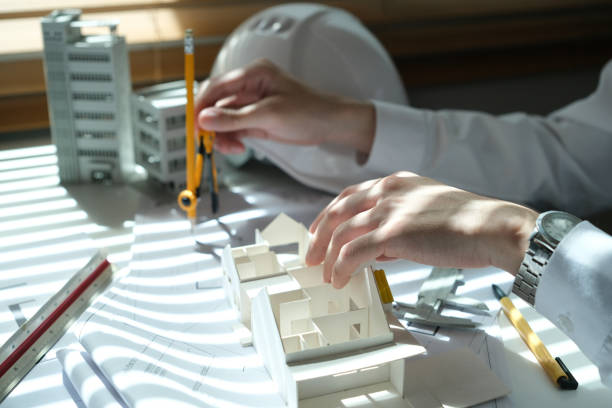 istock Architectural engineer man, contractors, designers, sketches, blueprints and construction work for architectural buildings. 1767216943