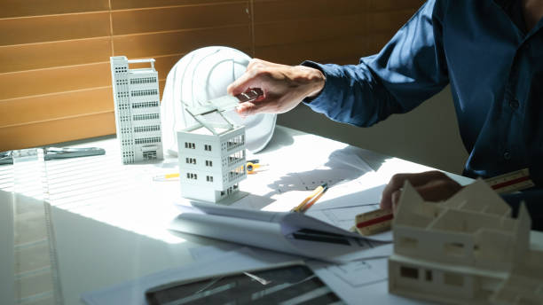 istock Architectural engineer man, contractors, designers, sketches, blueprints and construction work for architectural buildings. 1767219590