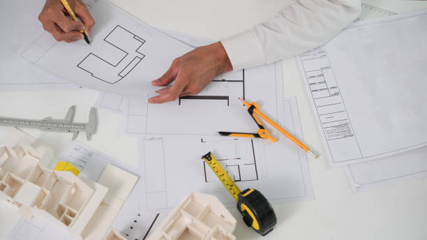 istock Architectural engineers, contractors, designers, sketches, blueprints and construction work for architectural buildings. 1767223425