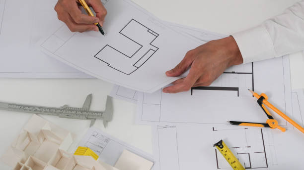 istock Architectural engineers, contractors, designers, sketches, blueprints and construction work for architectural buildings. 1767225556