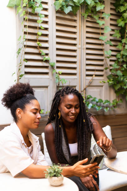 istock Distracted friends using phone on the yard of a cafeteria 1767231011