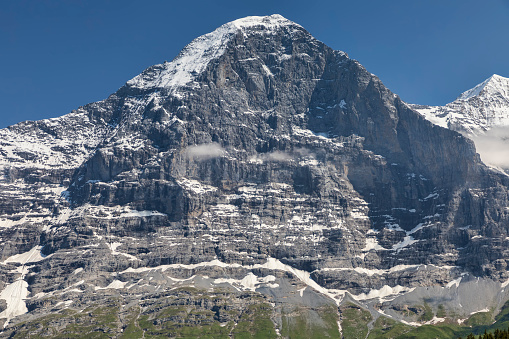 close up detail of the north face of the eiger in the bernese oberland switzerland sunny summer day