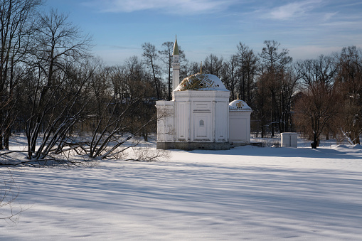 The pavilion of the Turkish Bath on the shore of a Large pond in the Catherine Park of Tsarskoye Selo on a sunny winter day, Pushkin, St. Petersburg, Russia