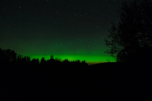 Northern Lights glowing over Caribou Lake in northern Minnesota, USA