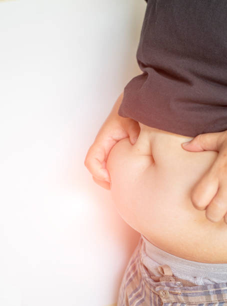 istock Big belly with fat accumulated under the skin on a white background with free space. 1767242559