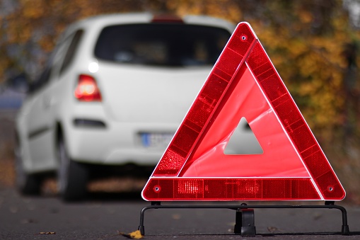 reflective triangle in front of a car breakdown