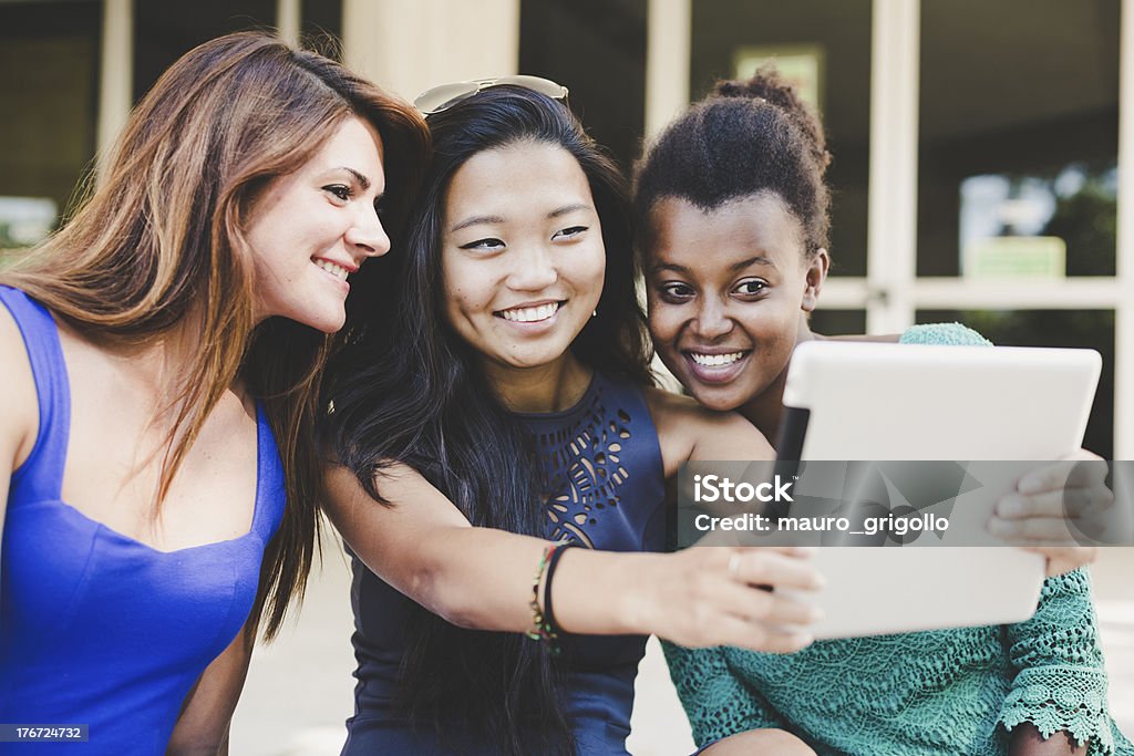 Three young women taking self portrait with digital tablet Three young women taking self portrait with a digital tablet. 18-19 Years Stock Photo