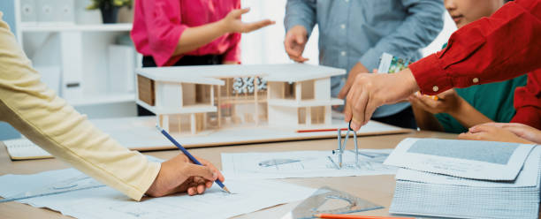 istock Professional architect team select sustainable house materials. Variegated. 1767247596
