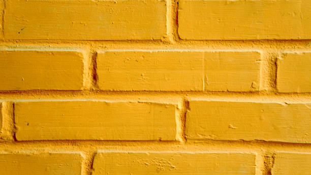istock Vibrant yellow brick wall as a background 176725228