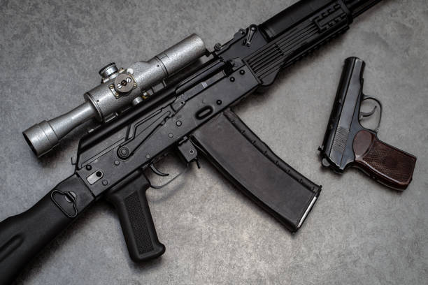 istock Rifle with old fashioned optical sight and retro pistol on the gray background 1767254689