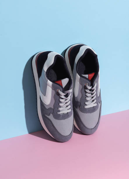 istock Sports sneakers on a blue pink background. Creative layout, minimalism 1767256335