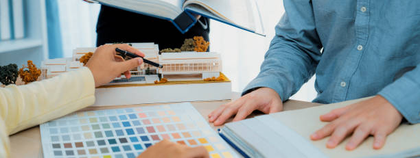 istock Interior design team discuss about color using for the project. Variegated. 1767261543