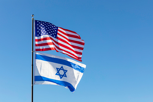 Waving Flags Of USA And Israel On The Same Flagpole On Background Of Blue Sky. Copy Space For Text. Design, Template Horizontal Plane High quality photo