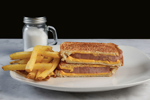spam melt sandwich served with a side of fries