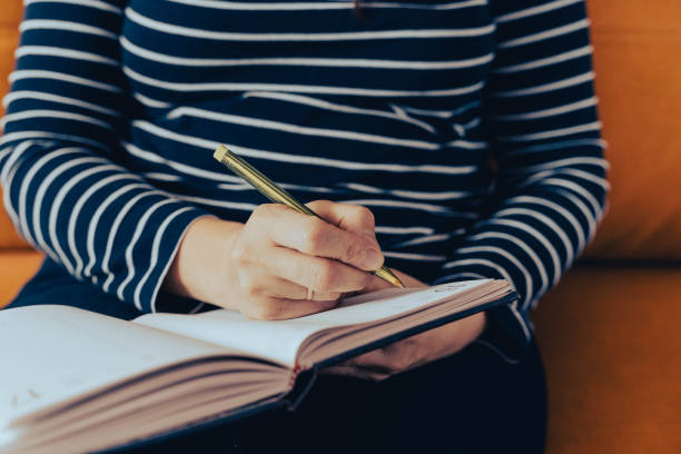 istock a woman makes notes of her thoughts in a notebook 1767276459