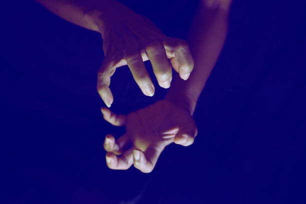 istock Hand and finger gestures show magic on black background with light and shadow. Look mysterious and hidden. Mysterious. 1767279758