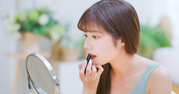 istock woman applying lipstick 1767279764