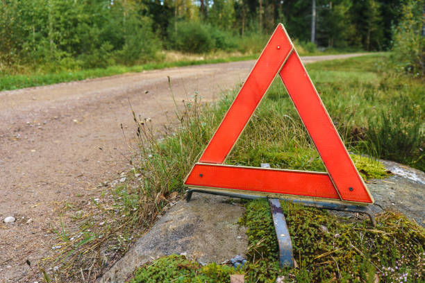 triangle de signalisation à côté d’une route de gravier en finlande. - reflector danger warning triangle vehicle breakdown photos et images de collection