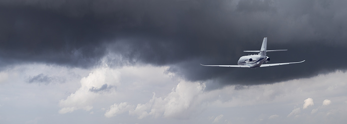 the plane flies through the storm clouds