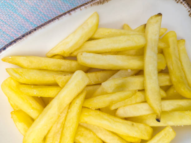 french fries in a plate closeup stock photo