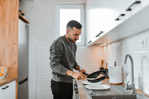 Careful Male Serving Omelette From Frying Pan