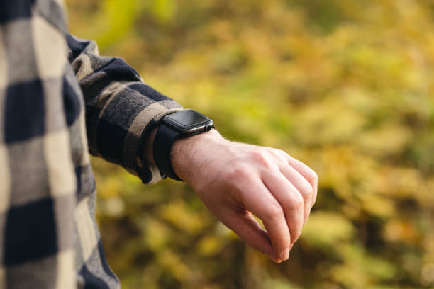 istock Close up, man using smart watch, setting up his smart watch in the forest. 1767307788