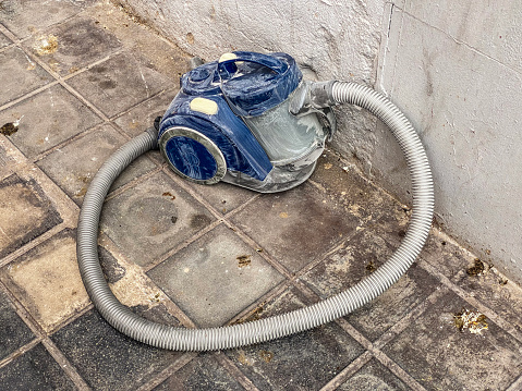 High angle view of vacuum cleaner abandoned in the street in the city of Valencia, Spain