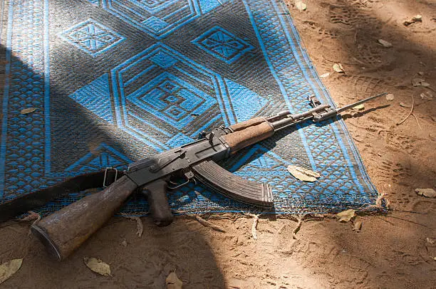 Photo of Ak47 gun on prayer mat