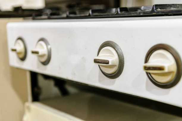 Knobs on an old fashioned gas hob and oven.