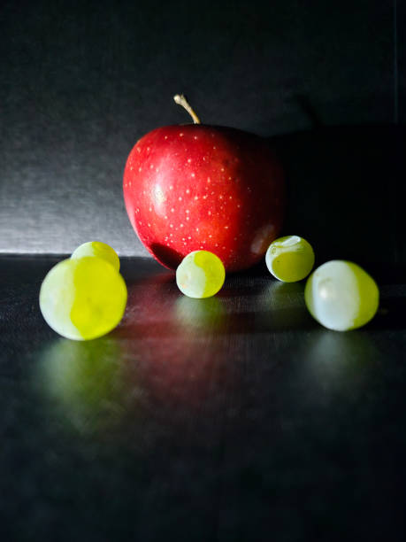 istock red apple with green grapes on dark background 1767361798