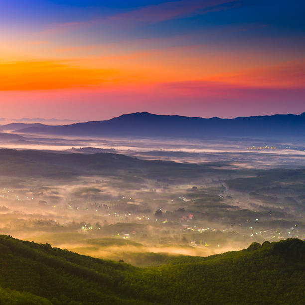 Beautiful sunshine at misty morning mountains .