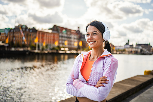 Portrait of a young female runner by the river in the city of Malmo, Sweden