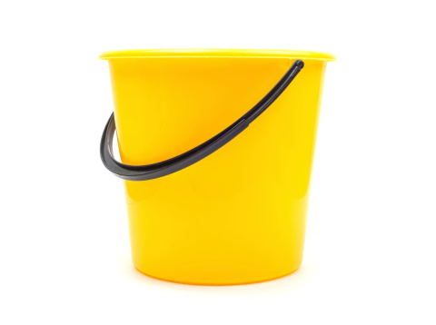 Yellow plastic bucket isolated on white