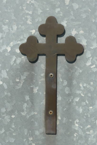 istock Old rust color cross on a light gray metal base plate. 1767376534