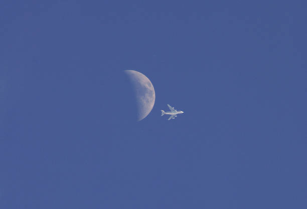 istock Airplane crossing the moon 176737752