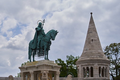 The statue of St Stephen, the Hungarian kind, built by the architect Alajos Stróbl in 1906, situated in the middle of Szentháromság square. Budapest, Hungary - 7 May, 2019