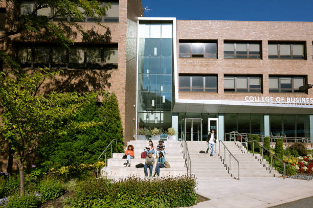istock Group of students sitting outside university building 1767388719