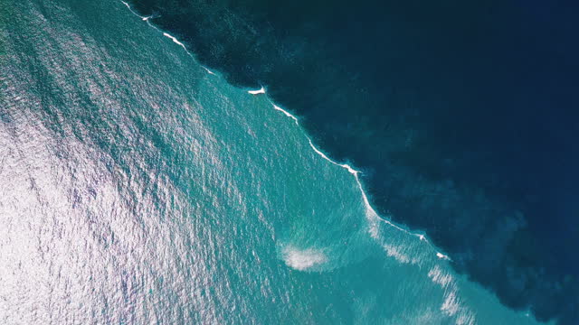 Boundary zone in the Atlantic Ocean. Aerial view of the dividing line of blue offshore water and murky coastal water in the ocean. Ocean water colliding zone