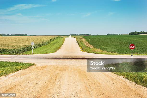 Crossroads Intersection Of Lonely Country Gravel Road With Highway Fields Stock Photo - Download Image Now