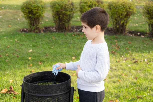 istock A child throws a plastic bag in the trash. Concept of garbage recycling, reducing plastic waste. 1767420458