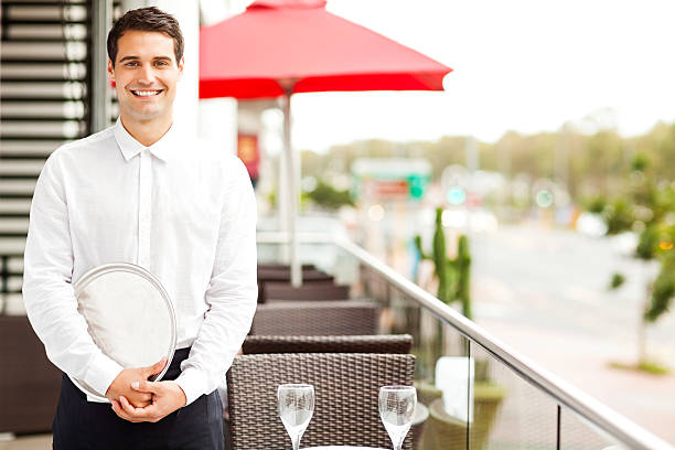 istock Waiter With Serving Tray Smiling In Restaurant 176742157