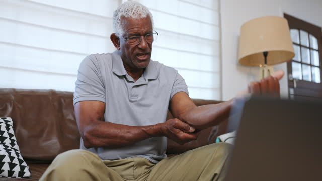 Senior black man with elbow joint pain
