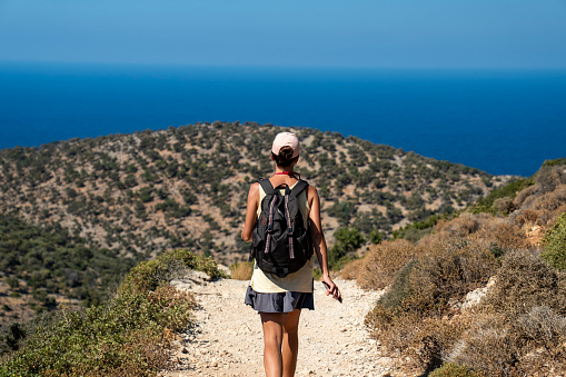 Summer vacations in the hot Greece on Crete island. Hiking trip in the steep rocky mountains