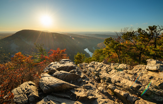 Tranquil sunset over Delaware Water Gap, New Jersey featuring sun over autumn colored mountains