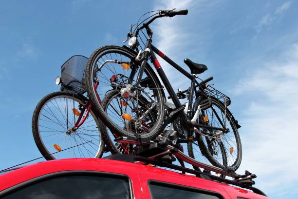bicycle rack on top of red car