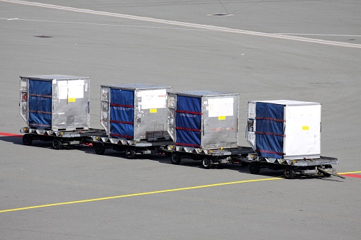 unit load devices on dollies at international airport