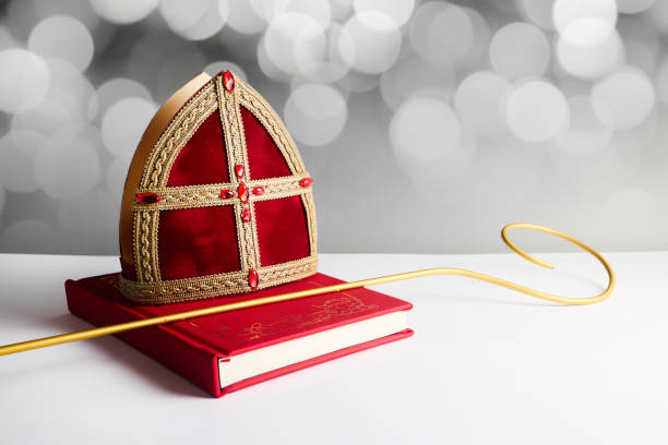 Dutch holiday Sinterklaas background with mitre or mijter staff and book of Sinterklaas. Dutch holiday Sinterklaas background with mitre or mijter staff and book of Sinterklaas mijter stock pictures, royalty-free photos & images